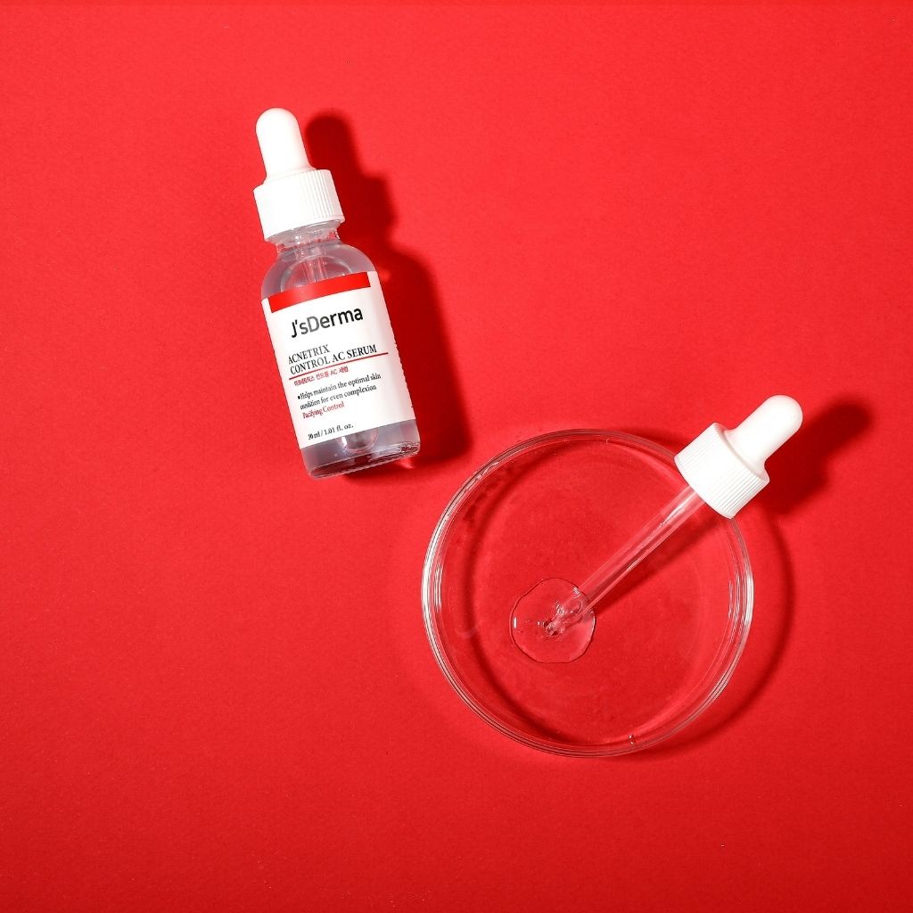 SsDerma skincare serum bottle with dropper on a red background