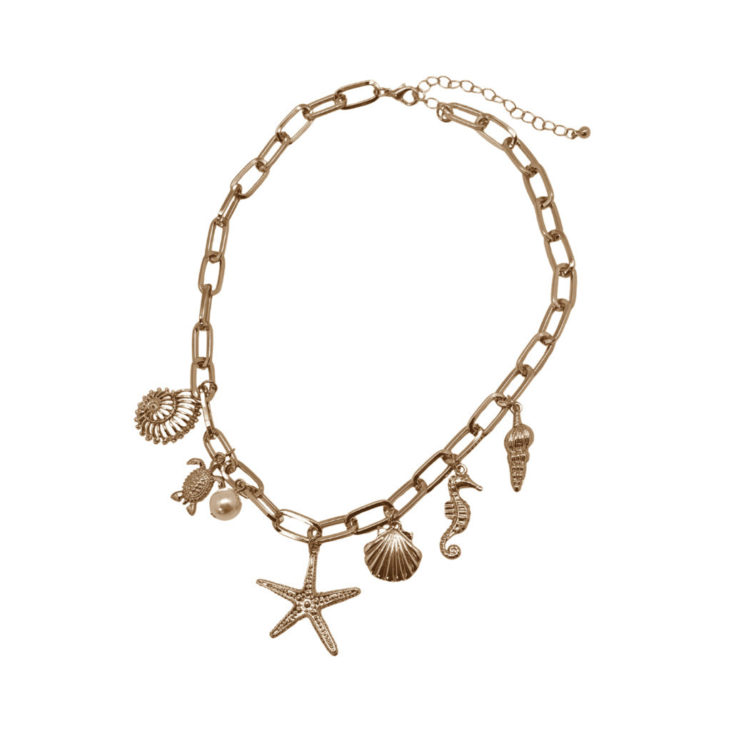 Gold chain necklace with various sea-themed charms on a white background