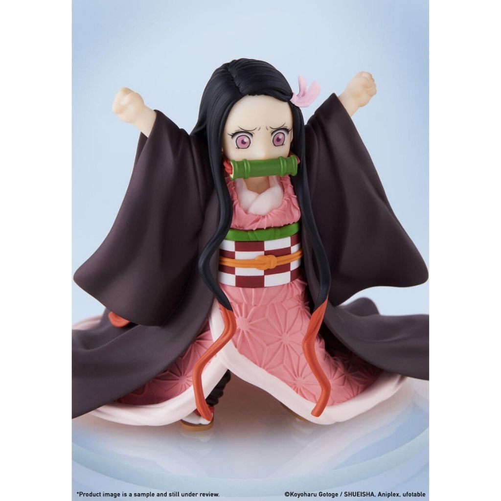 Anime character figurine with black hair and pink outfit on a light blue background