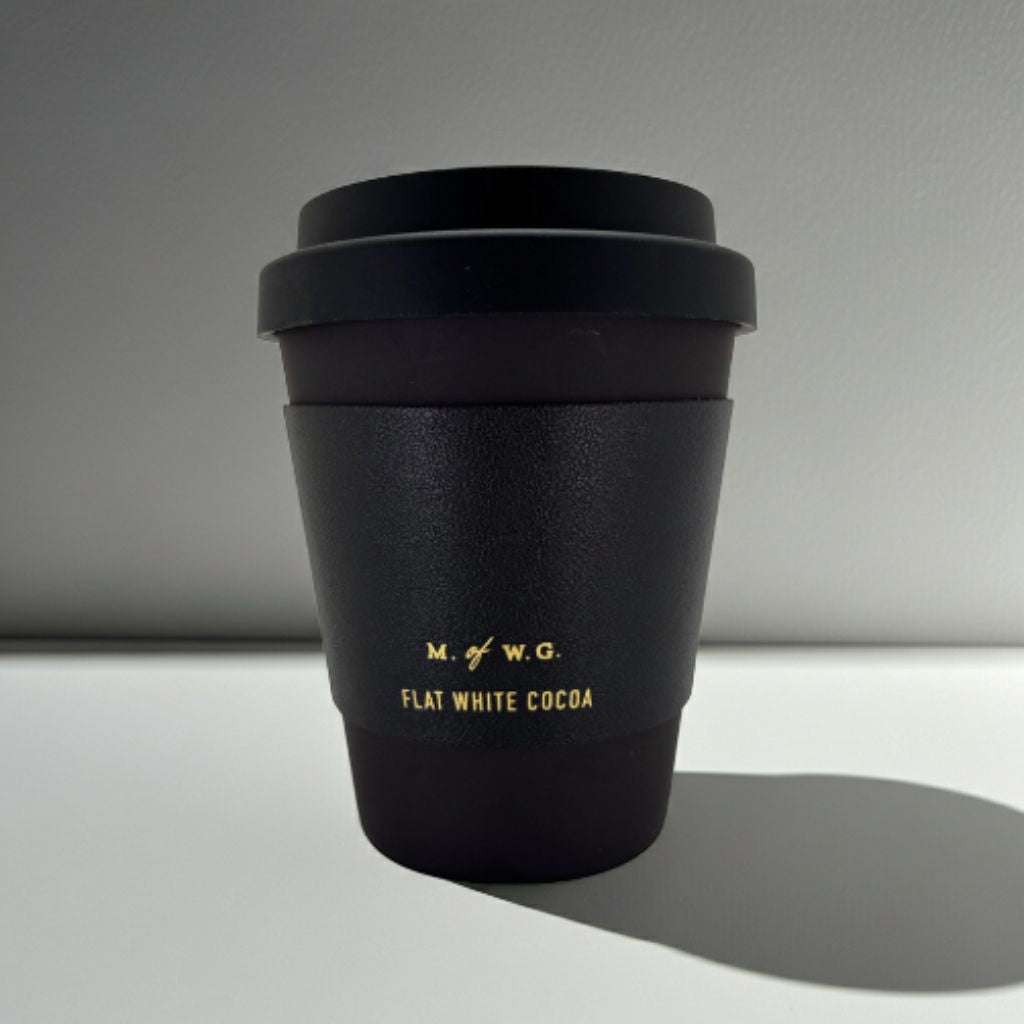 Black coffee cup with lid on a gray background