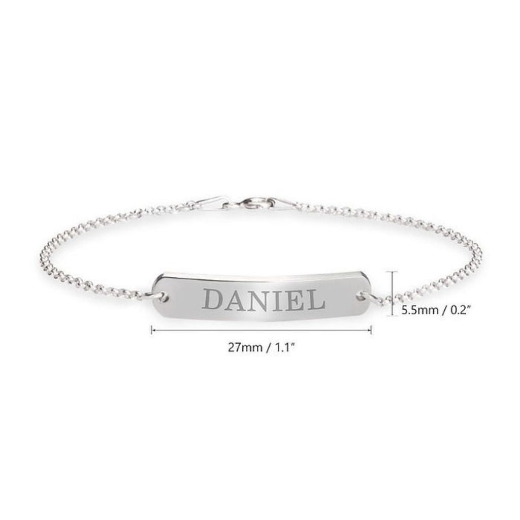 Silver bracelet with engraved name 'DANIEL' on a white background