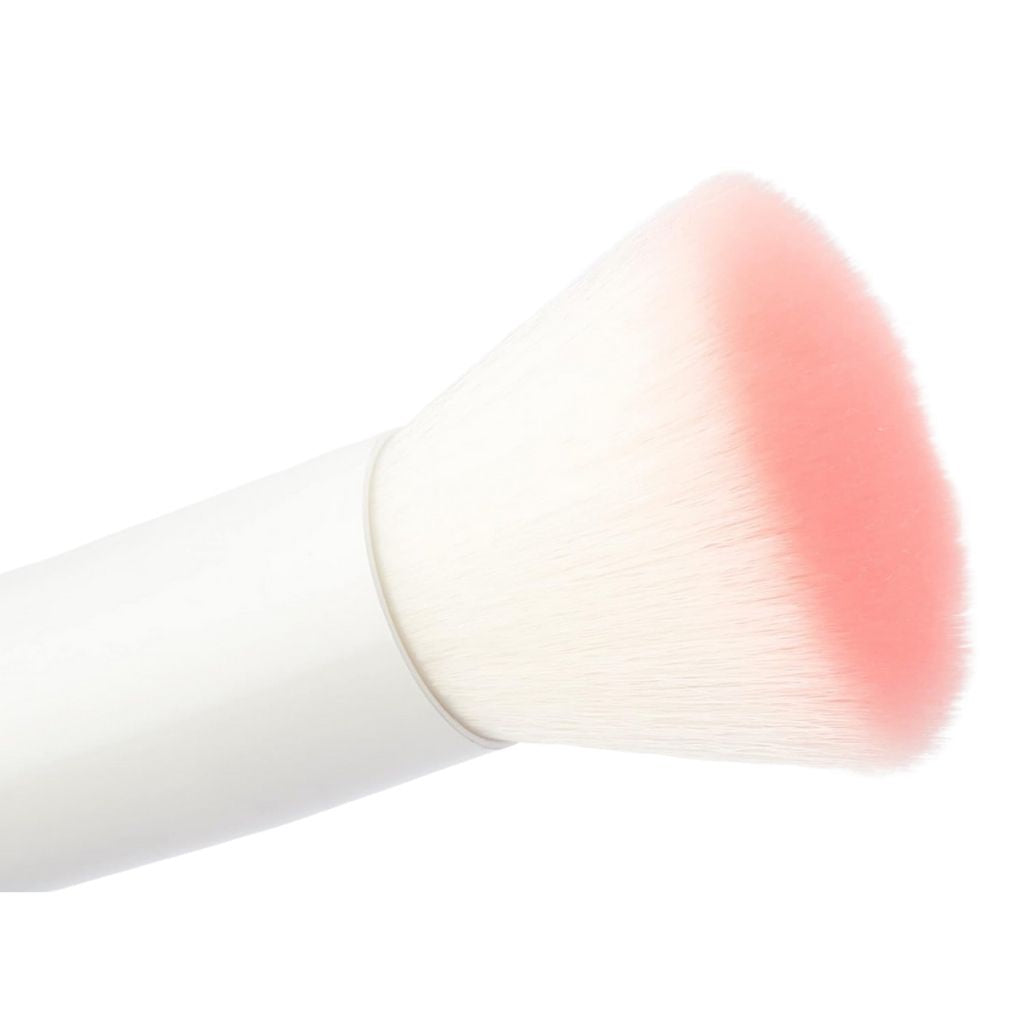 Makeup brush with pink blush on a white background