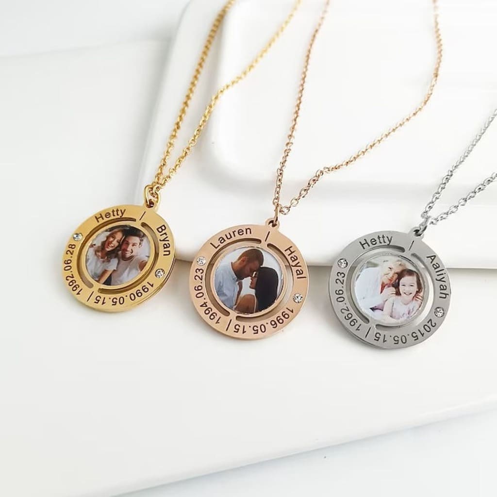 Three necklaces with circular pendants featuring photos and text on a white surface