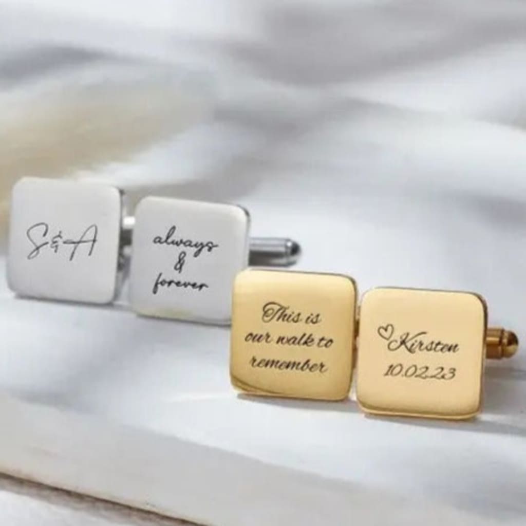 Personalized cufflinks with engraved text on a white background