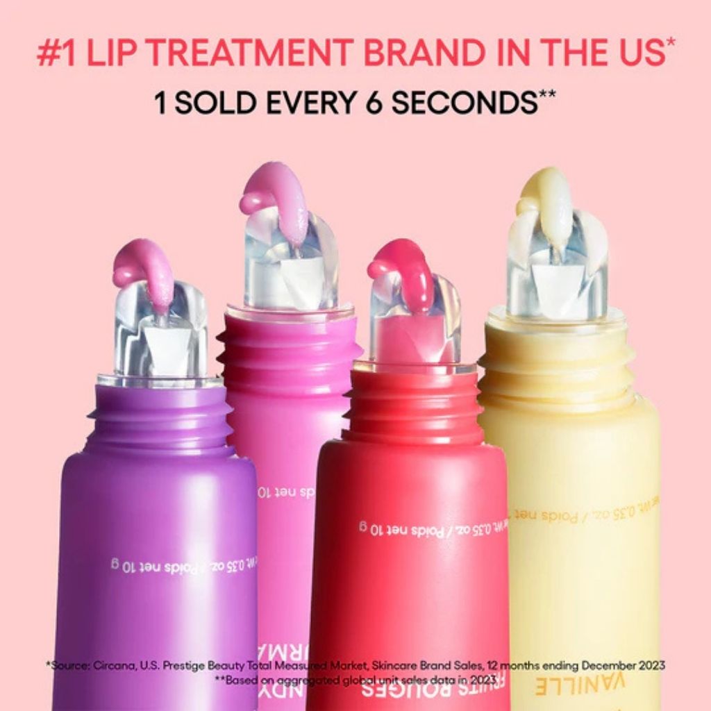 Four lip treatment bottles in purple, pink, red, and yellow on a pink background with text about being the #1 lip treatment brand in the US.