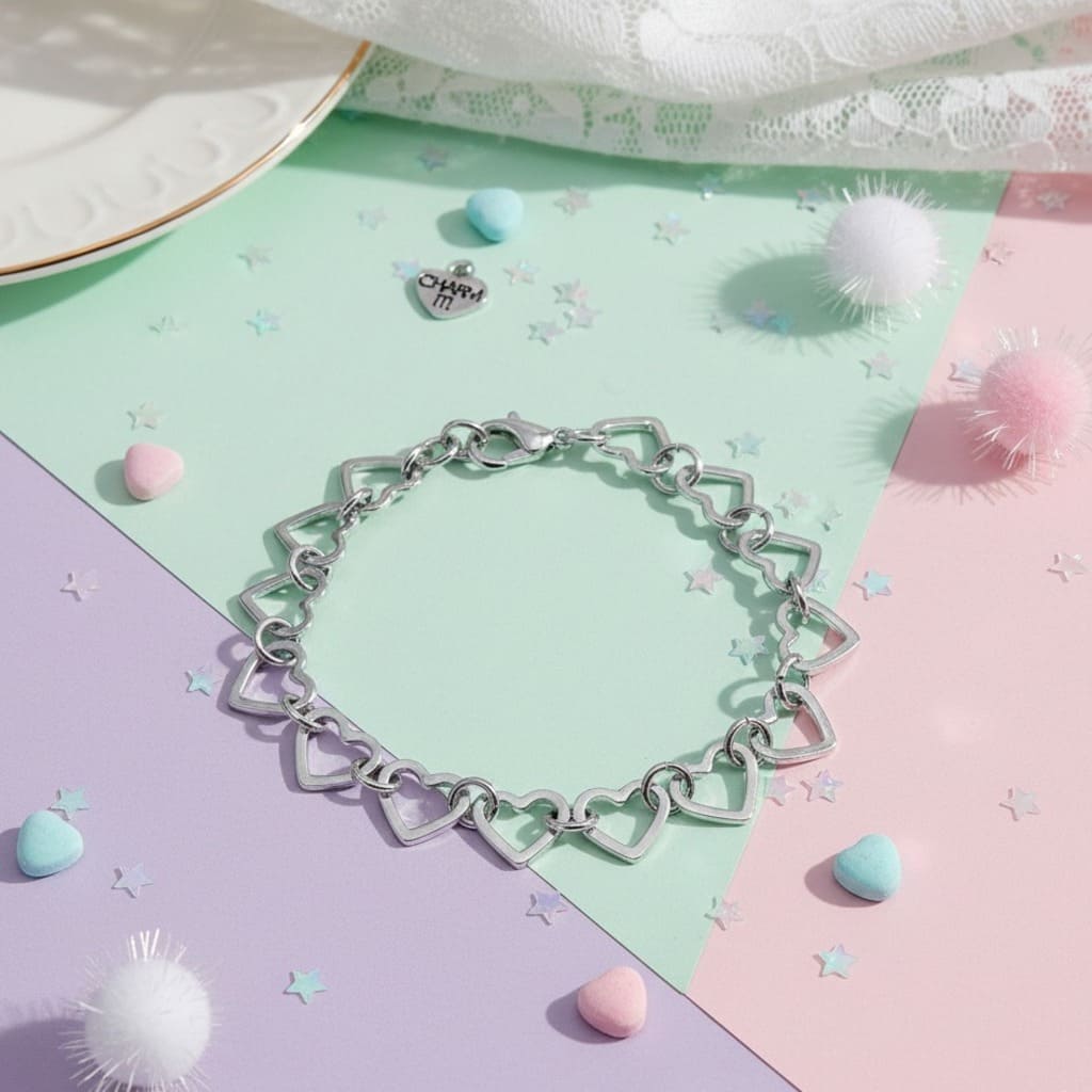 Silver heart-shaped bracelet on a colorful pastel background with decorative elements.