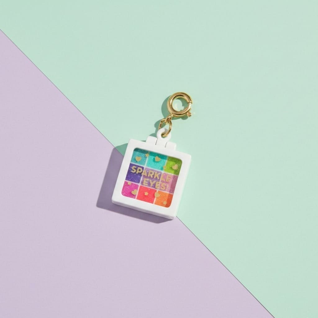 Keychain with 'Sparkle Eyes' design on a pastel background