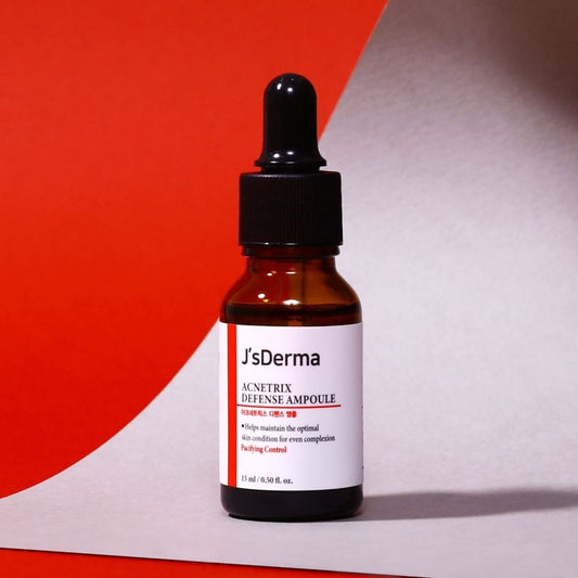J'sDerma skincare ampoule bottle with dropper on a red and gray background