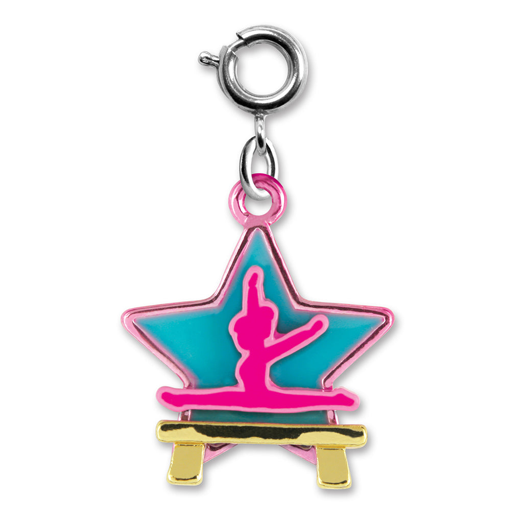 Star-shaped charm with a gymnast on a balance beam, pink and blue design, on a white background.