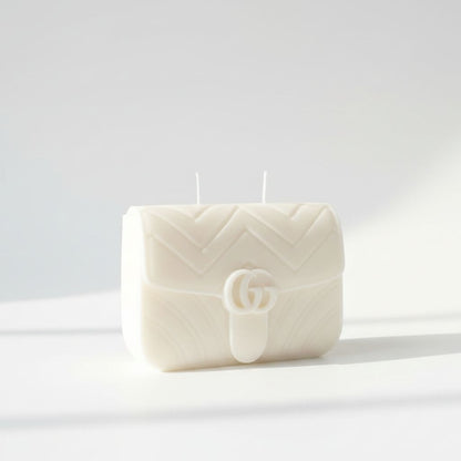 White quilted handbag-shaped candle on a white background