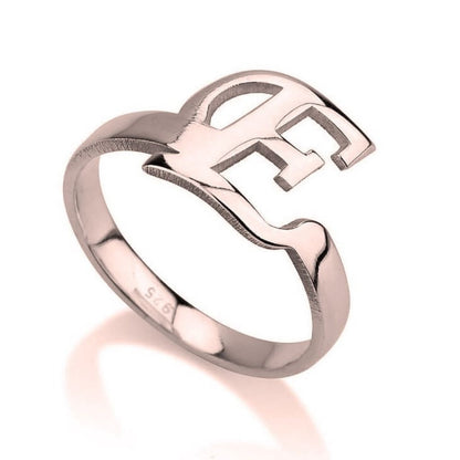 Rose gold ring with a heart-shaped design on a white background