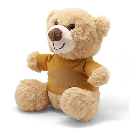 Plush teddy bear wearing a mustard yellow shirt on a white background