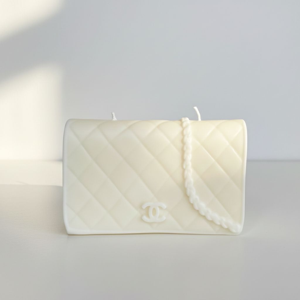 Candle shaped like a Chanel handbag on a white background