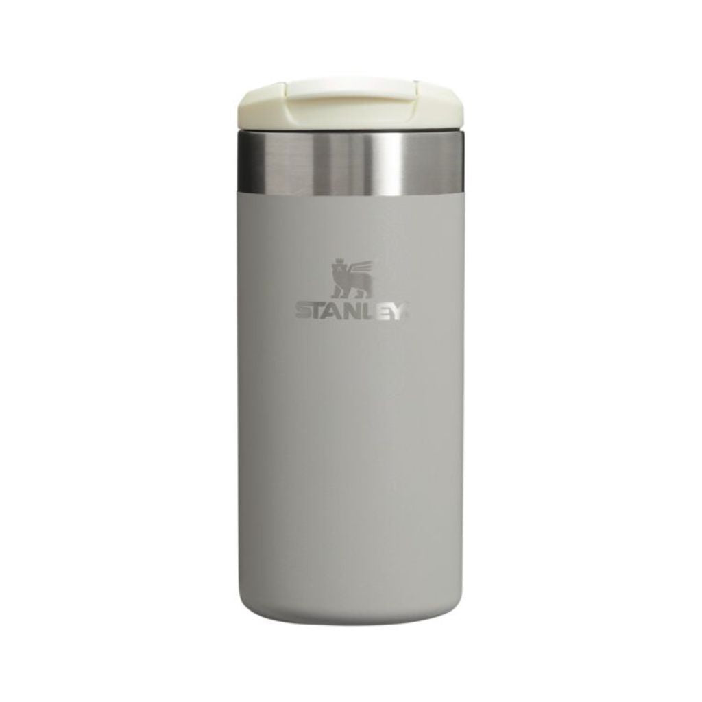 Gray Stanley tumbler with a white lid on a white background