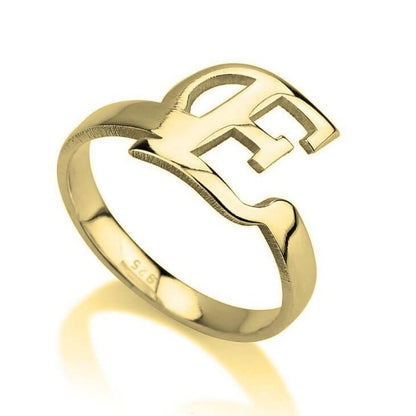 Gold ring with a unique design on a white background