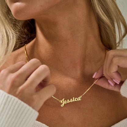 Gold necklace with 'Jessica' pendant on a person's neck