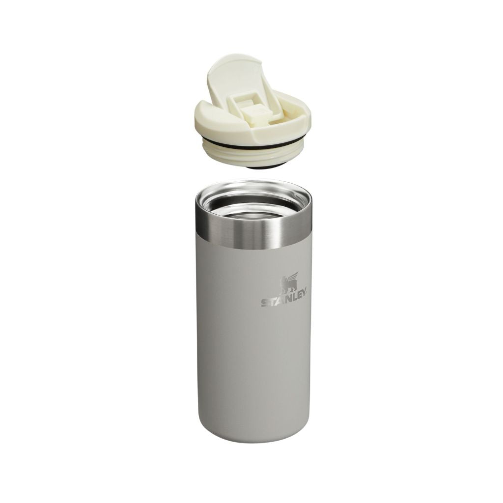 Stainless steel tumbler with white lid on a white background