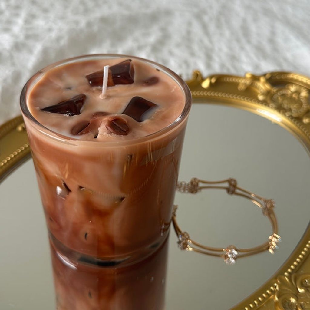 Candle shaped like a glass of iced coffee on a decorative tray