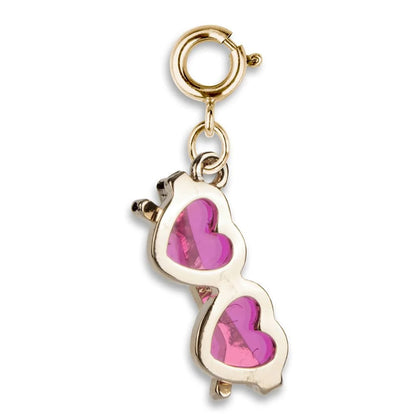 Gold charm with pink heart design on a white background