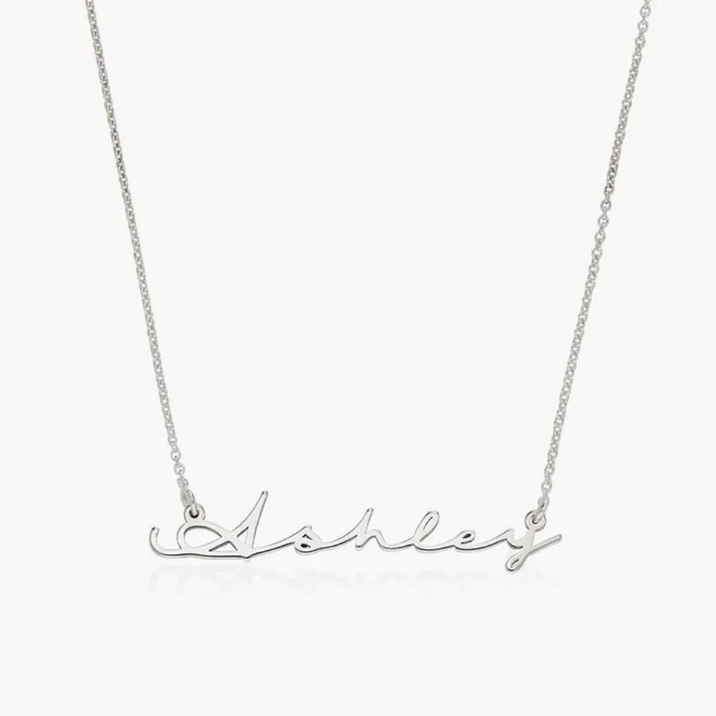 Silver necklace with 'Ashley' script on a white background