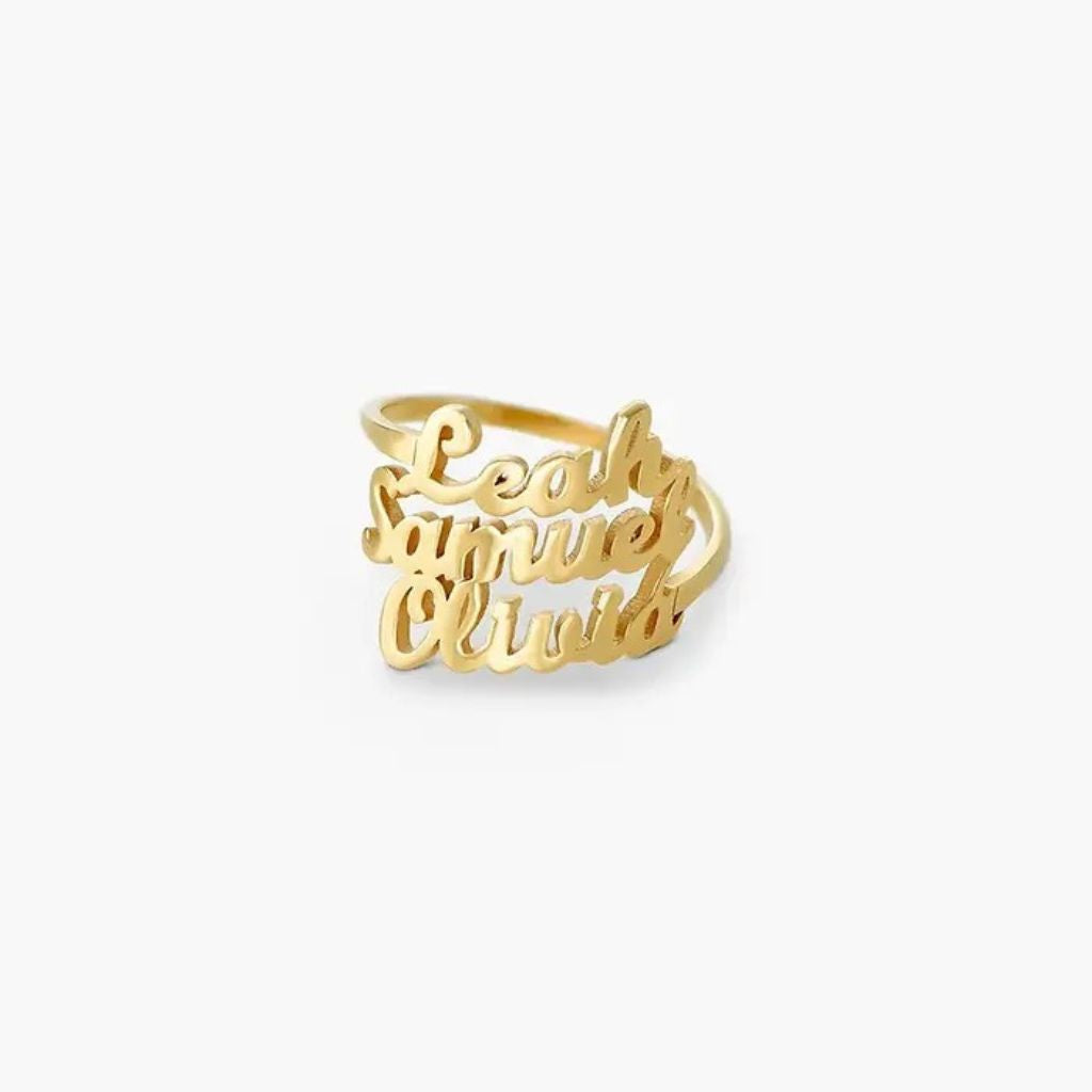 Gold ring with engraved names on a white background