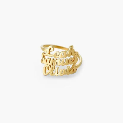 Gold ring with engraved names on a white background