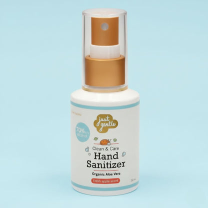 Hand sanitizer bottle with gold cap on a light blue background