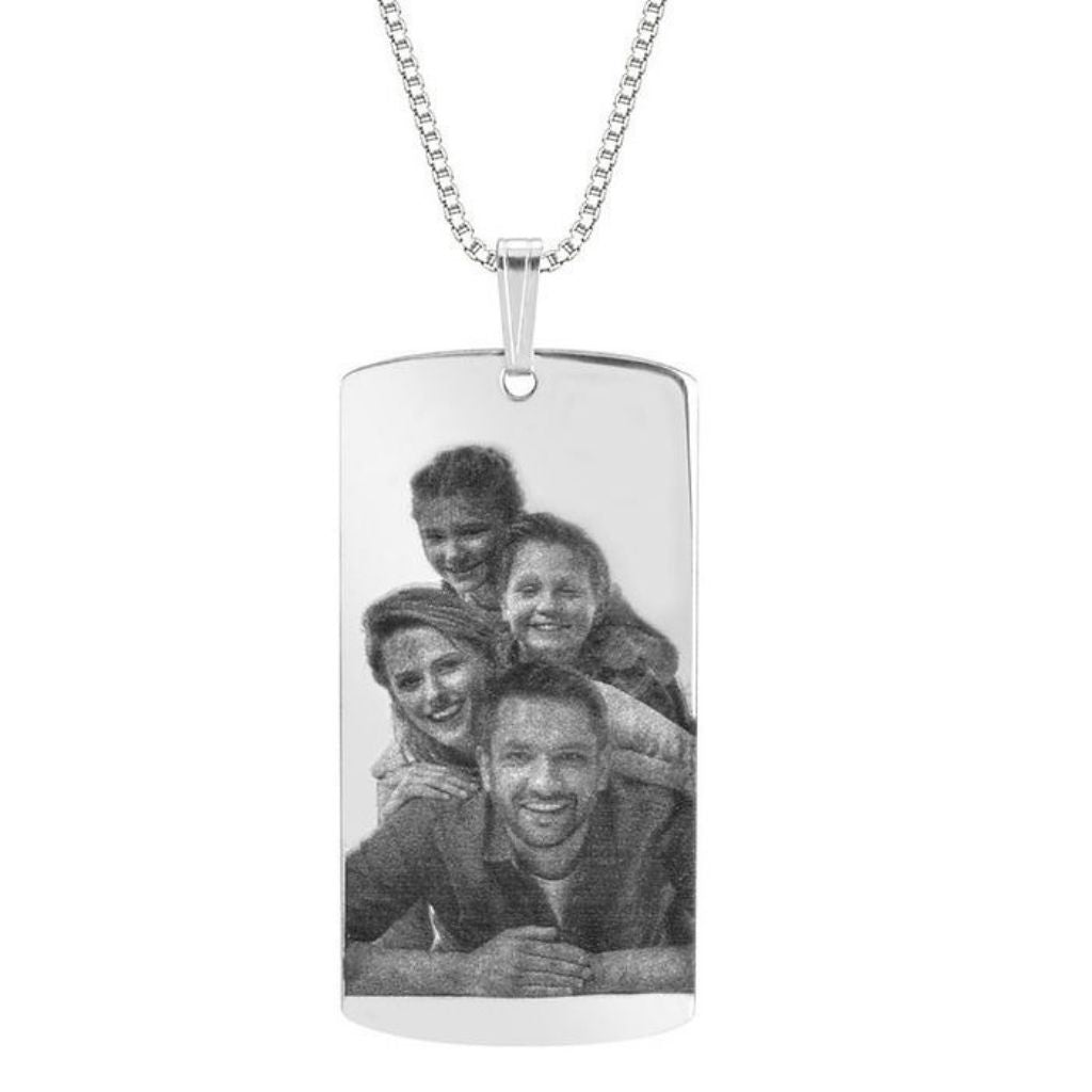 Dog tag pendant with a photo of four people on a white background