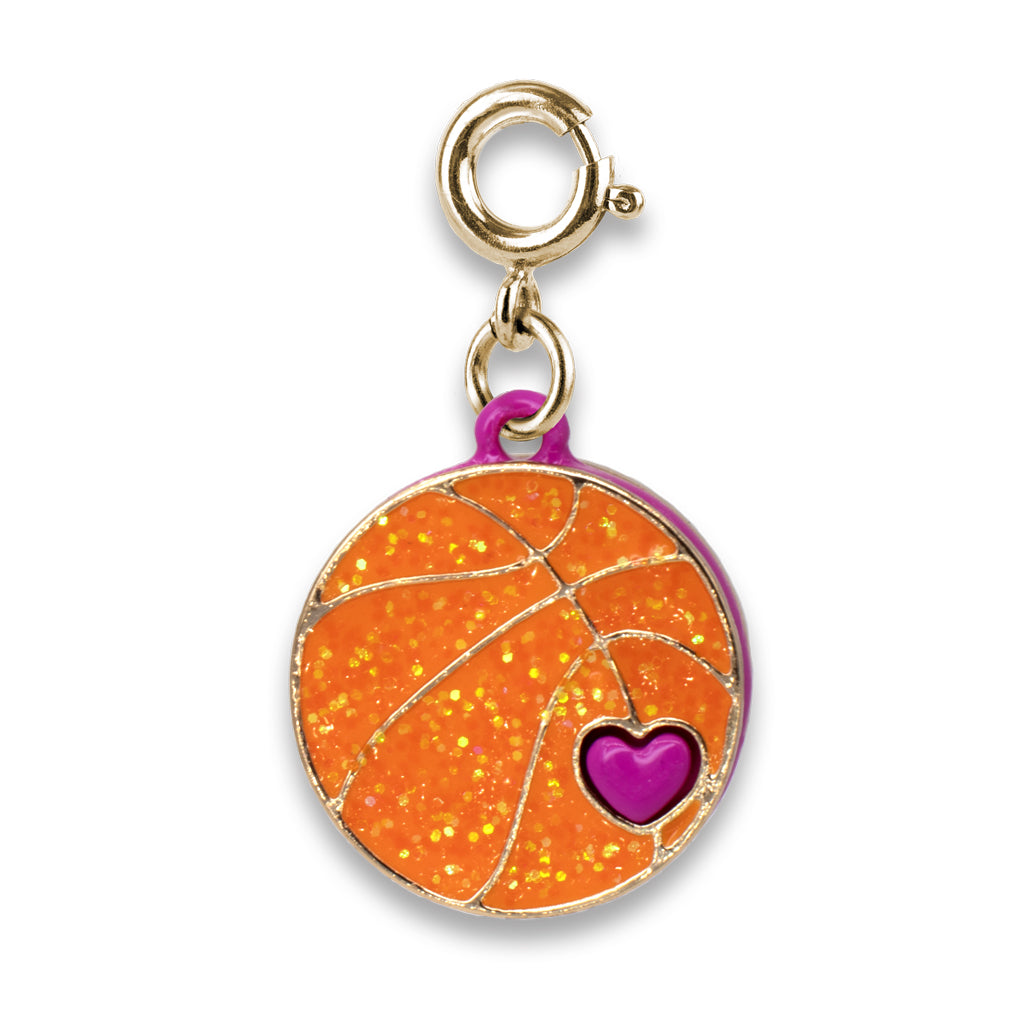 Gold charm with orange glittery surface and purple heart on a white background