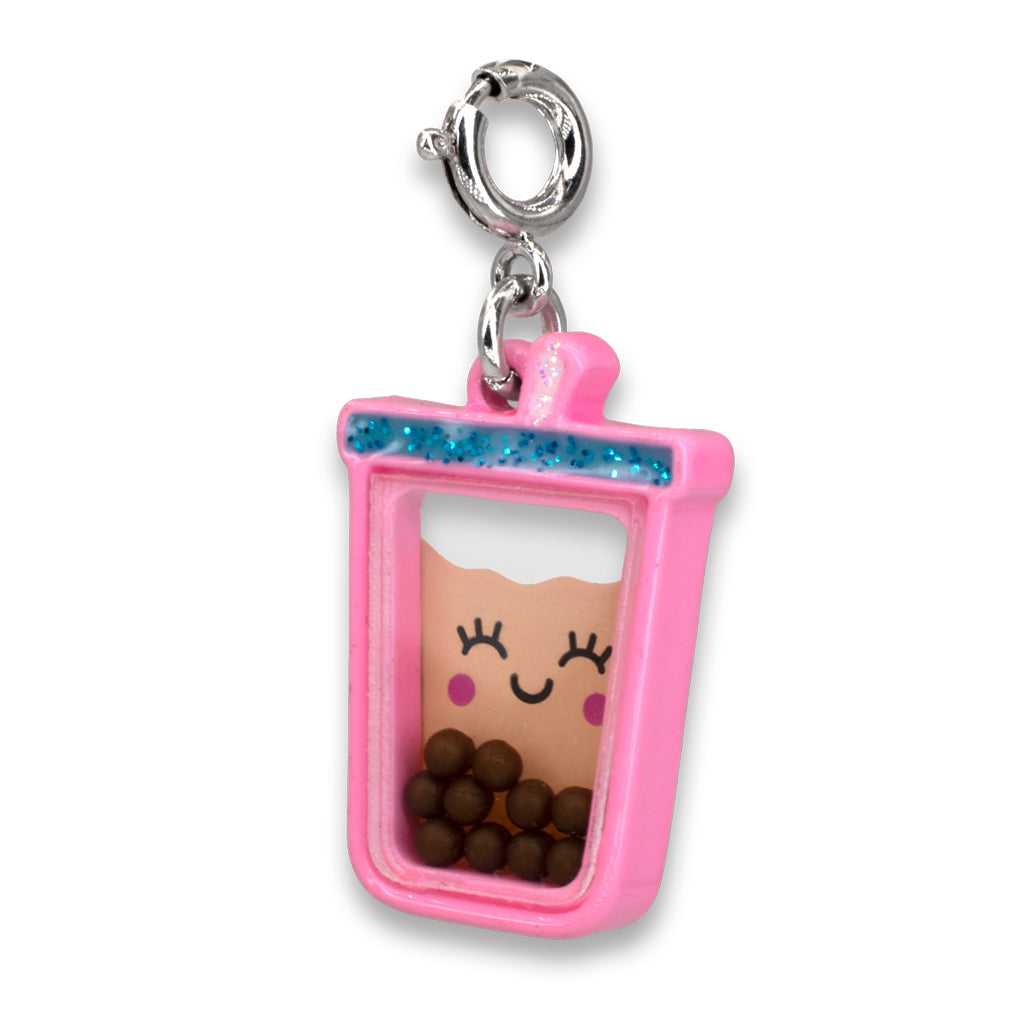 Pink character charm with a smiling face and chocolate balls inside on a white background