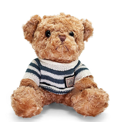 Teddy bear wearing a striped sweater on a white background