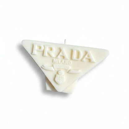 White Prada logo candle on a white background