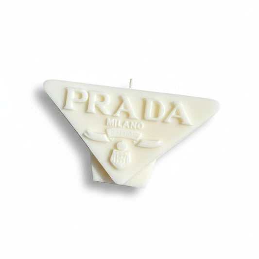 White Prada logo candle on a white background