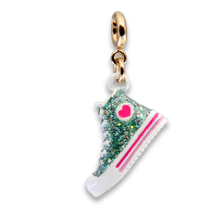 Glittery sneaker charm with pink accents on a white background