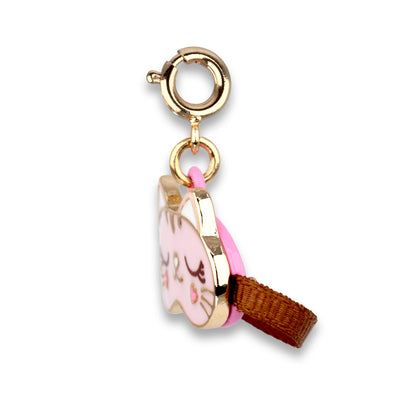 Gold charm with a pink character design on a white background