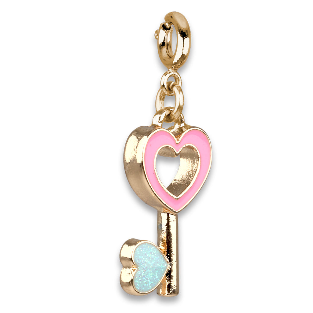 Gold key-shaped charm with pink heart and blue lock on a white background