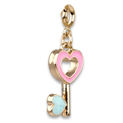 Gold key-shaped charm with pink heart and blue lock on a white background