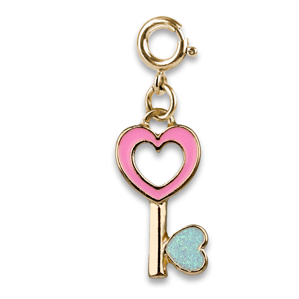 Gold charm with pink heart and blue heart key on a white background