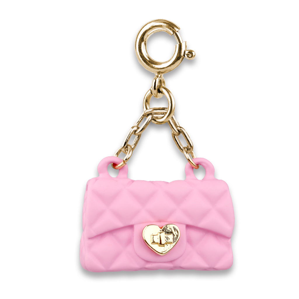 Pink quilted handbag charm with gold heart detail on a white background