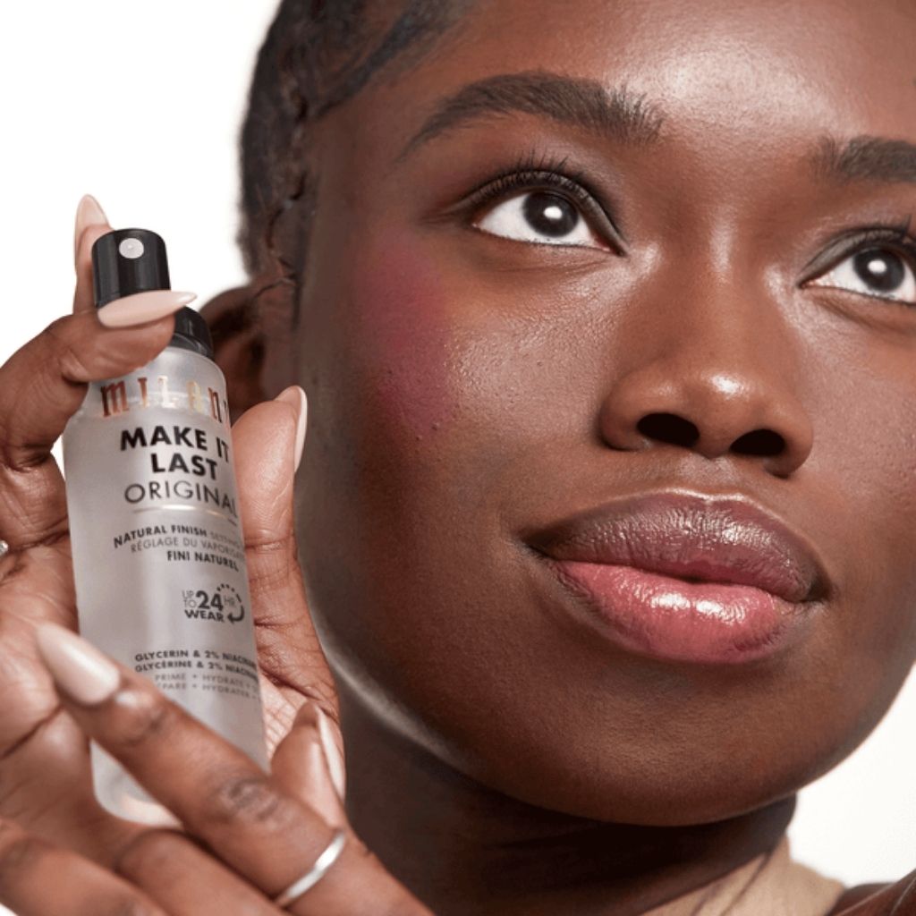 Woman holding a makeup product close to her face
