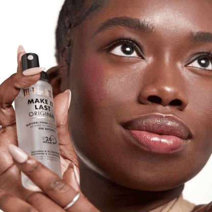 Woman holding a makeup product close to her face