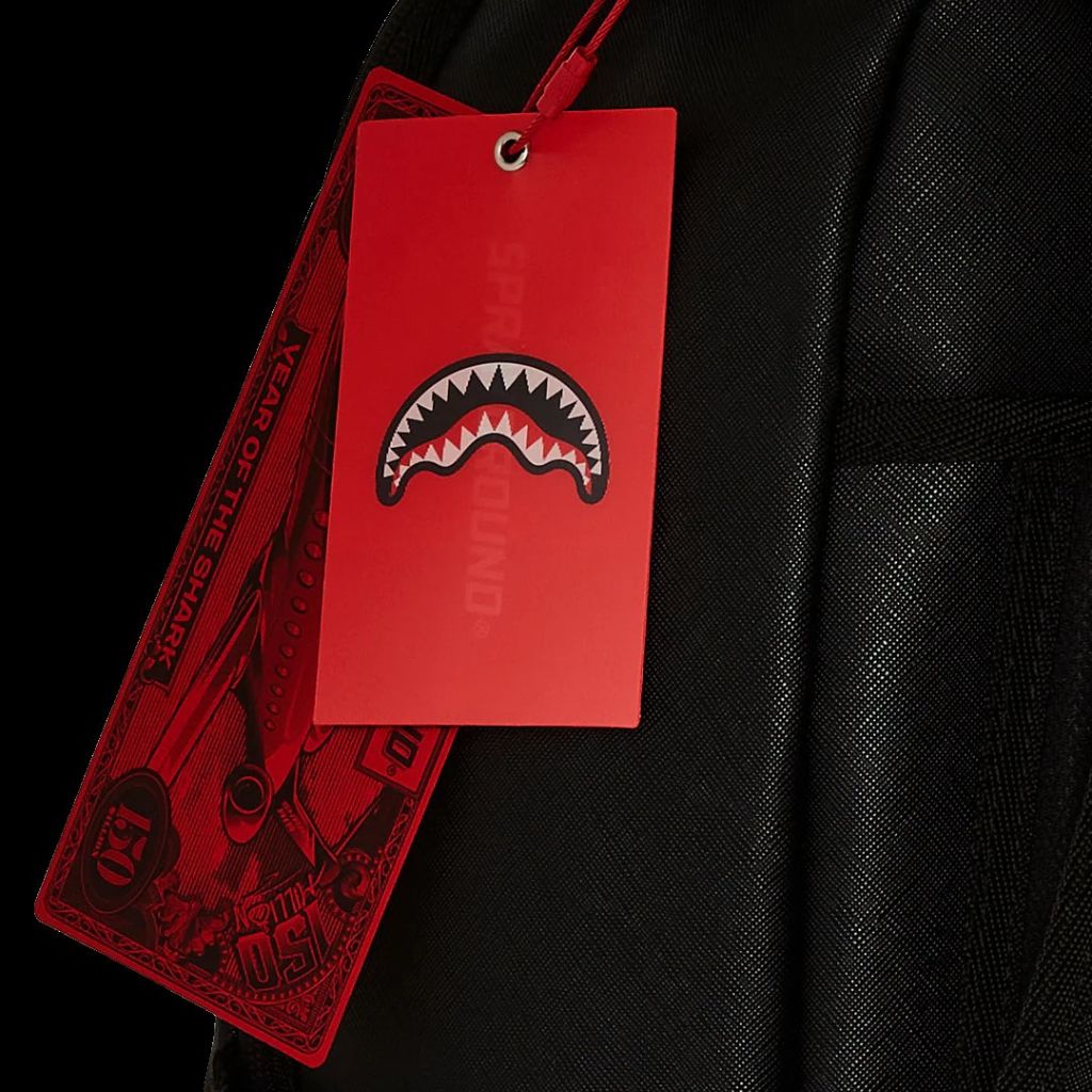 Black leather jacket with a red tag featuring a shark logo on a black background