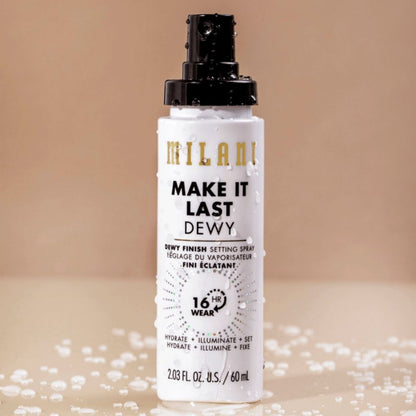 Milani Make It Last Dewy setting spray bottle on a beige background