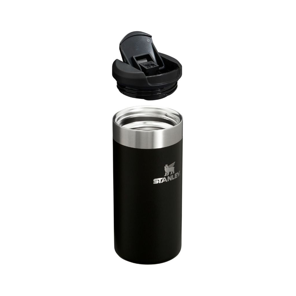 Black Stanley tumbler with a silver lid on a white background