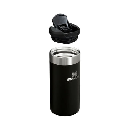 Black Stanley tumbler with a silver lid on a white background