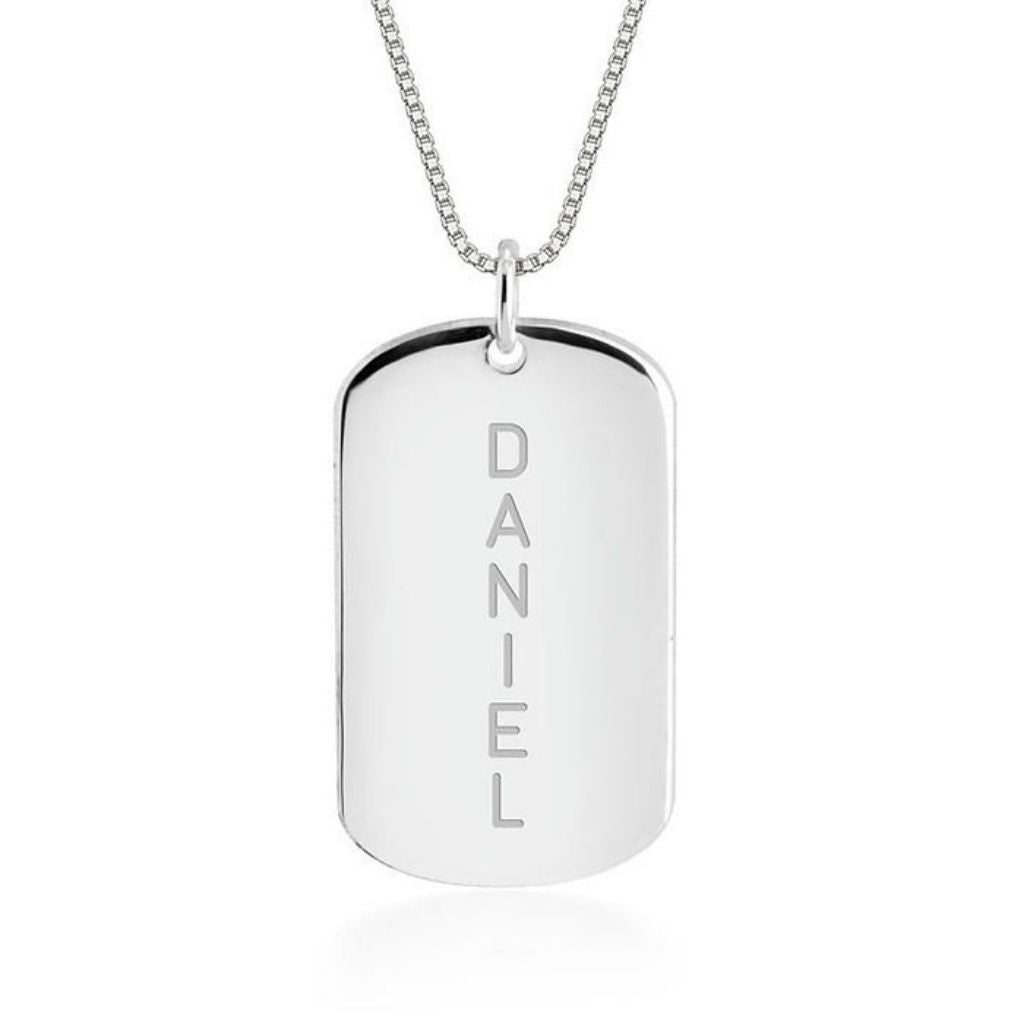 Silver dog tag necklace with 'DANIEL' engraving on a white background