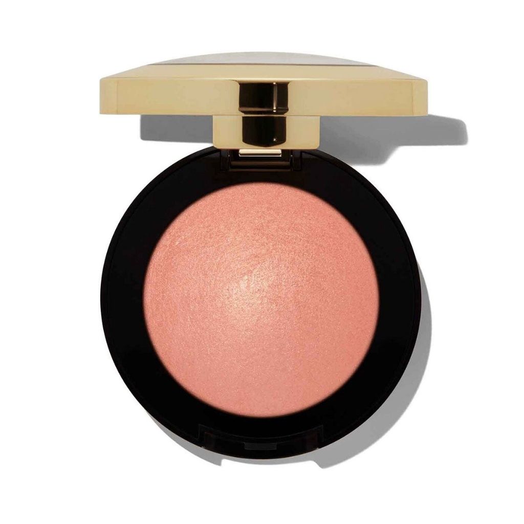 Compact blush in a black case with a gold lid on a white background
