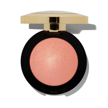 Compact blush in a black case with a gold lid on a white background