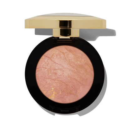 Compact blush with a gold lid on a white background