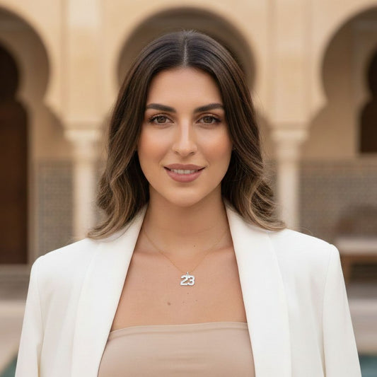Woman wearing a necklace with the number 23 in front of architectural background